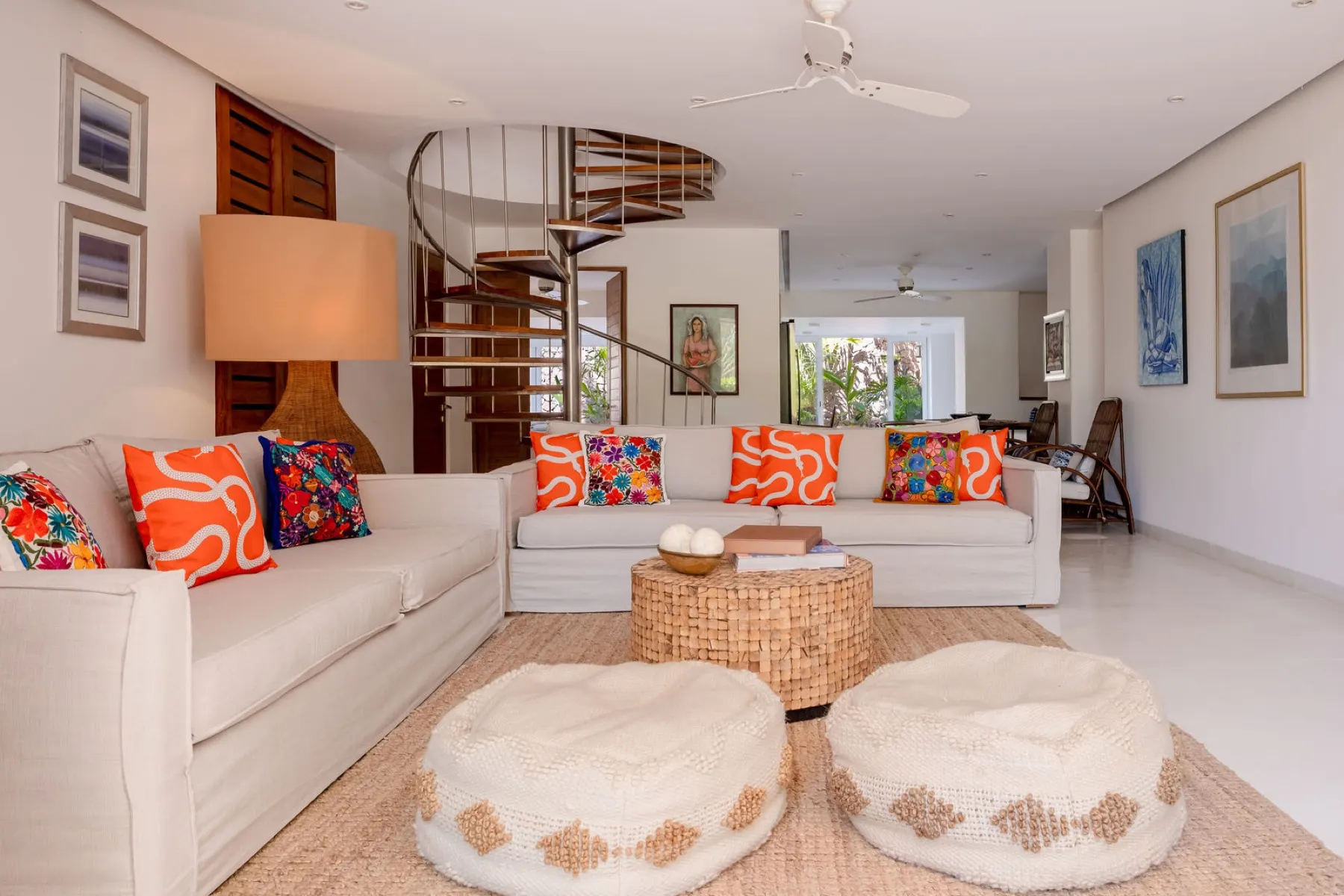 Living room of a three-bedroom residence with coral accents