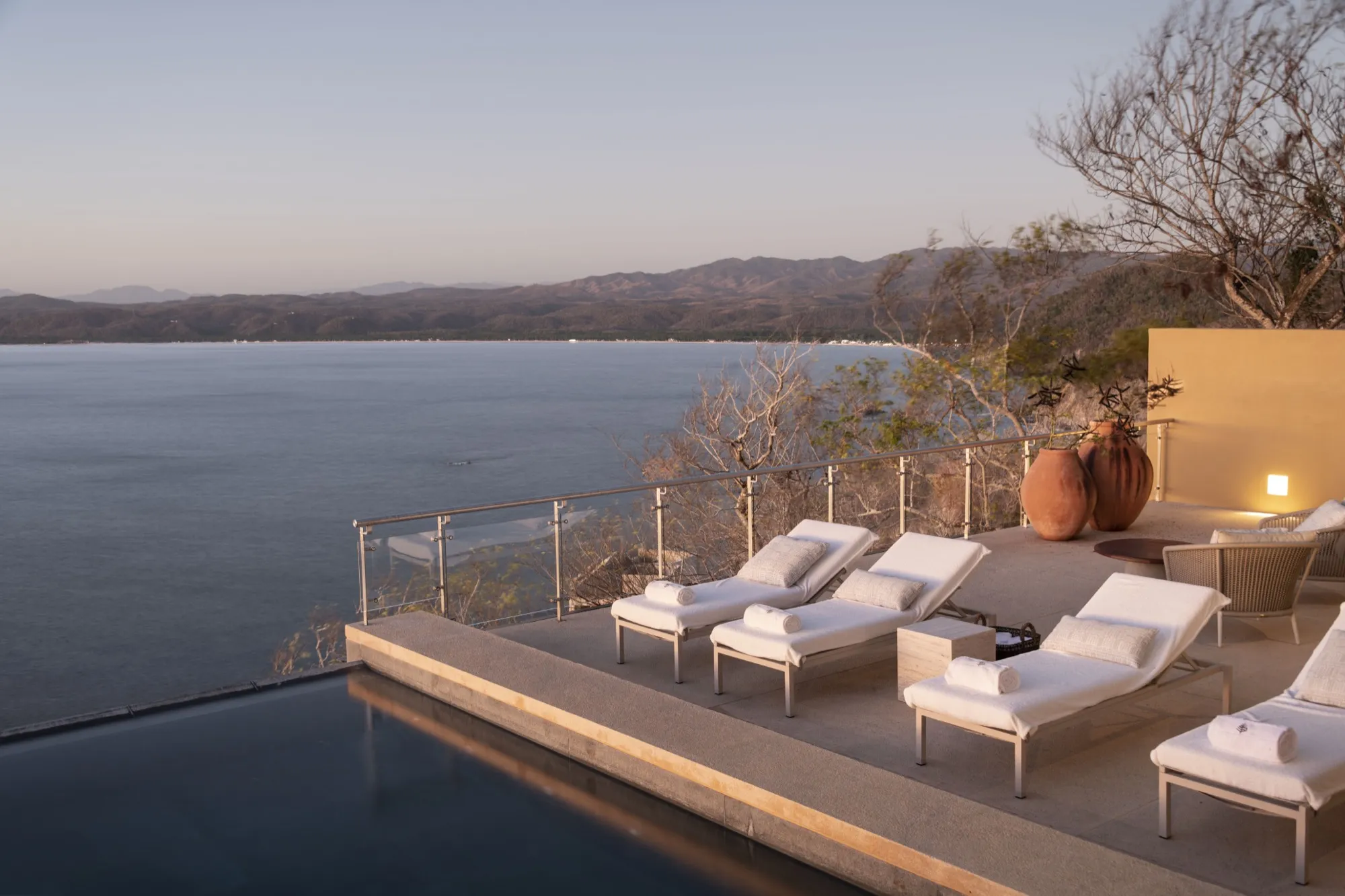 Infinity pool of a Las Alturas villa at dusk, above Tenacatita Bay