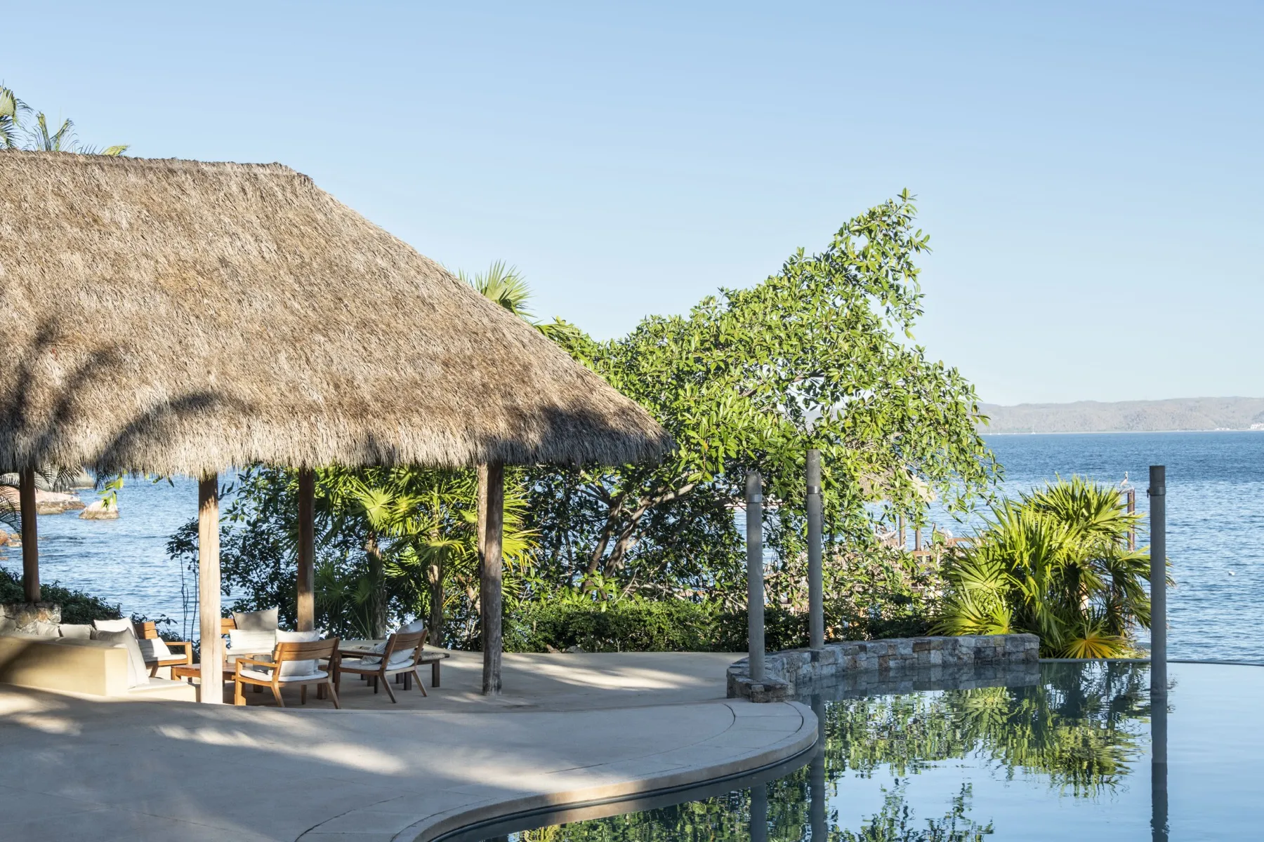 Ocean-facing pool and palapa of a Las Arenas beachfront estate