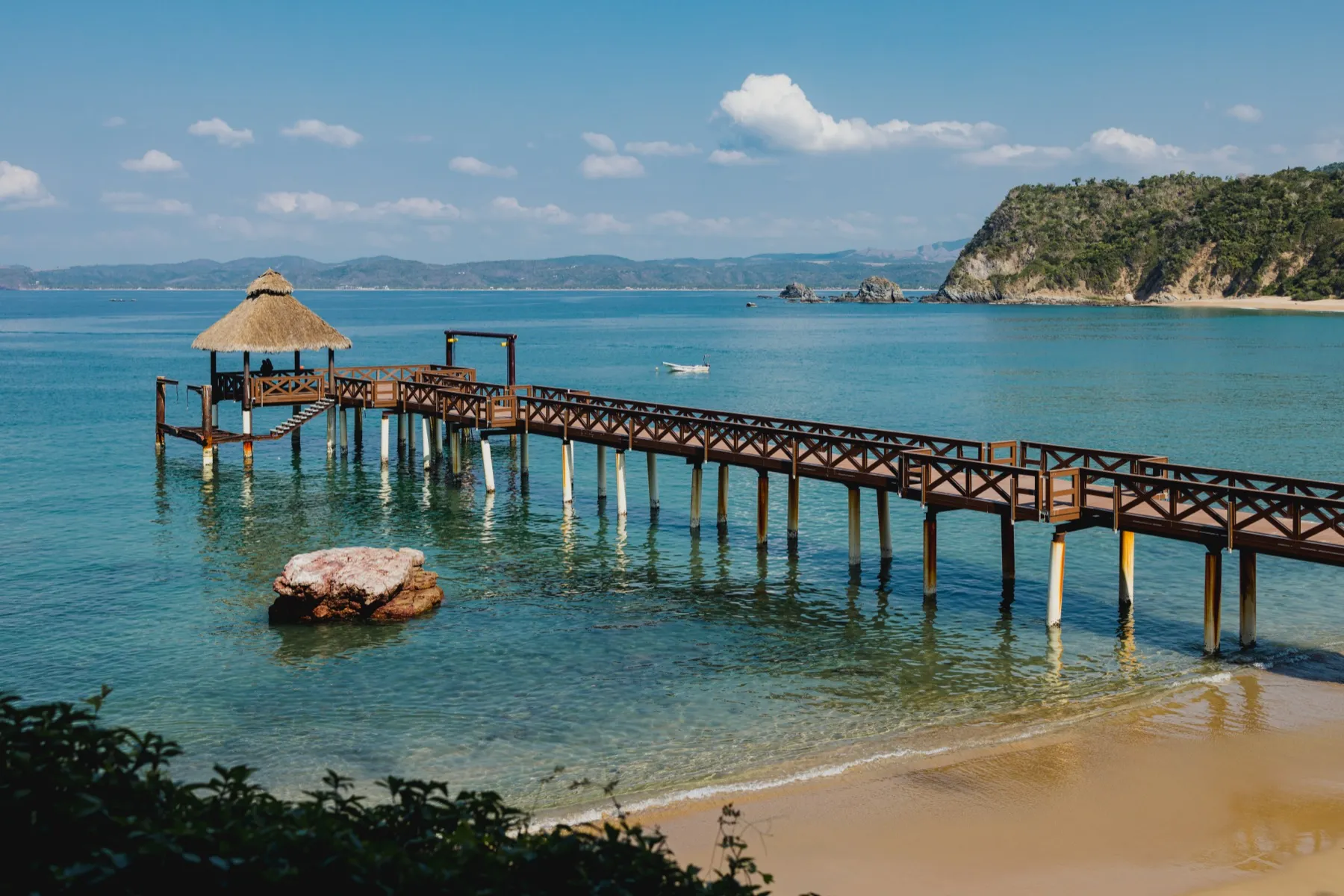 Wooden pier over the calm water of the bay