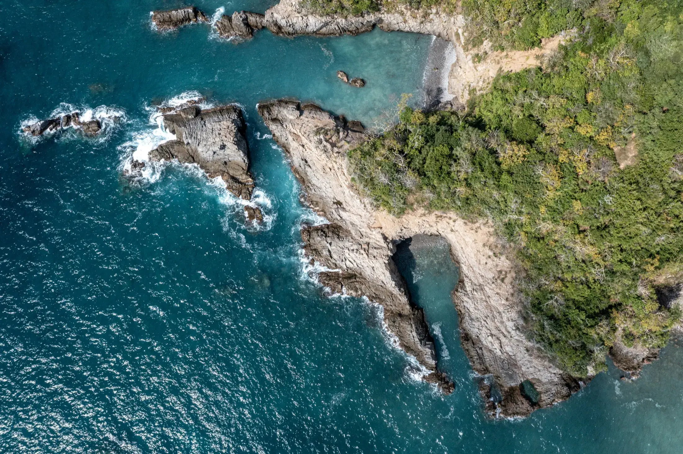 Aerial view of the rocky Tamarindo coastline and reserve